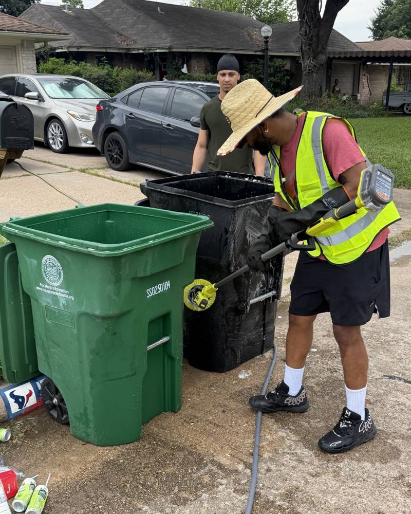 Crew washing a bin